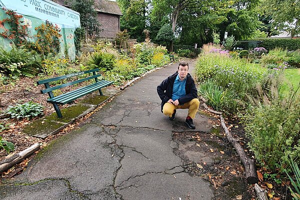 Cllr Will Frass with the old cracked path Cllr Will Frass with the old cracked path