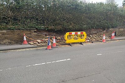 The collapsed wall which is blocking the whole pavement The collapsed wall which is blocking the whole pavement