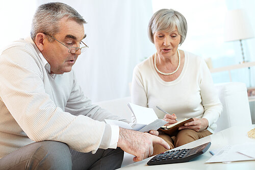 An elderly couple working out their finances.